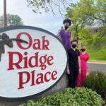 Oak Ridge Place sign with people